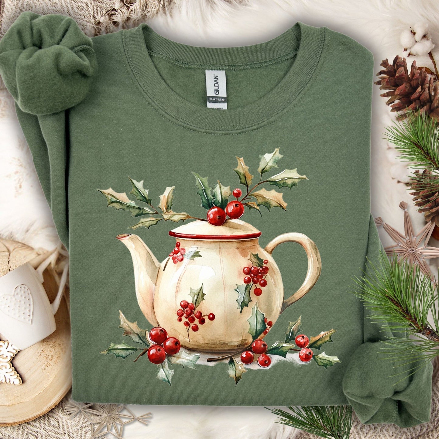 Military Green Gildan fleece sweatshirt with a watercolor farmhouse Christmas teapot and holly design.