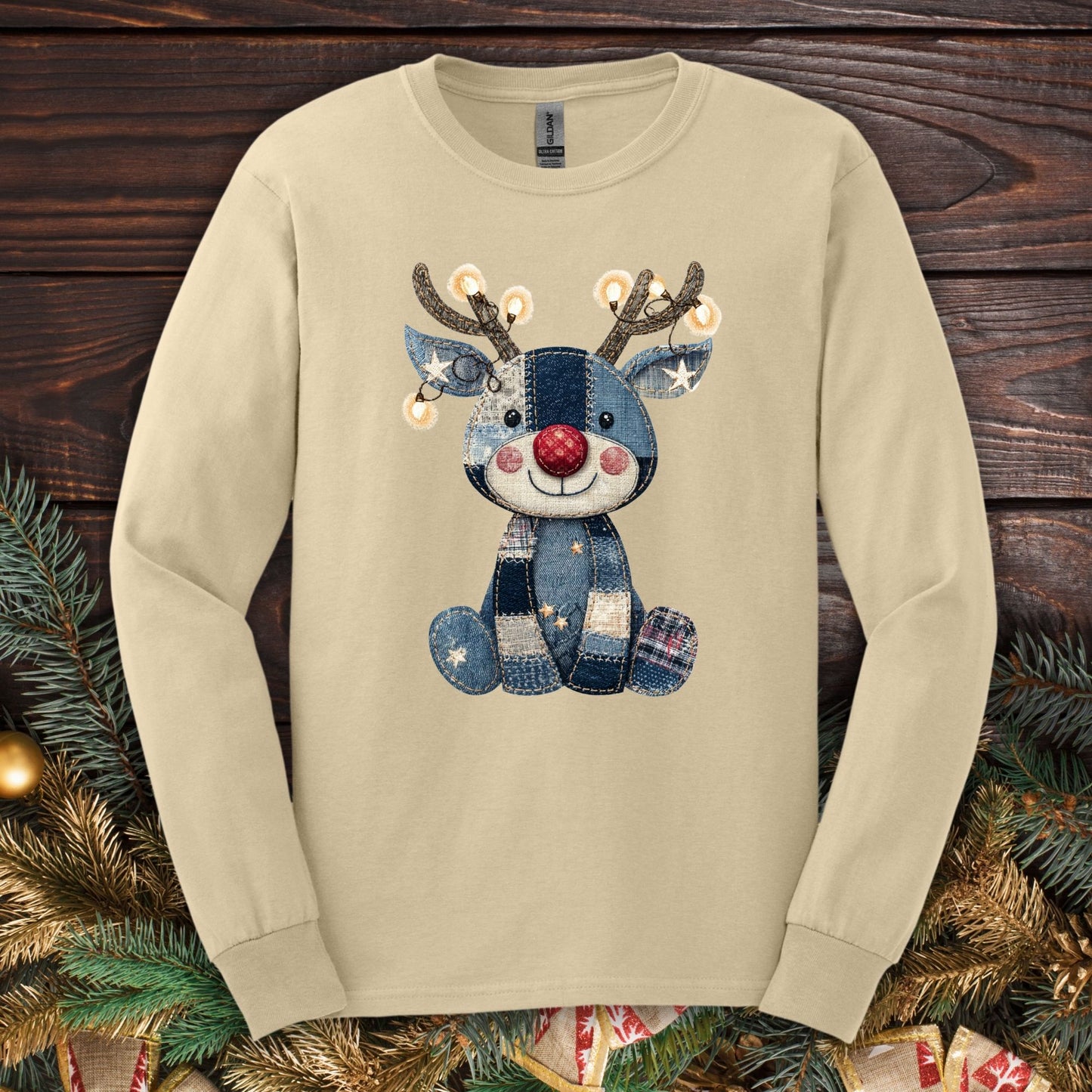 Sand long sleeve tee with a faux denim patchwork Rudolph wearing Christmas lights.