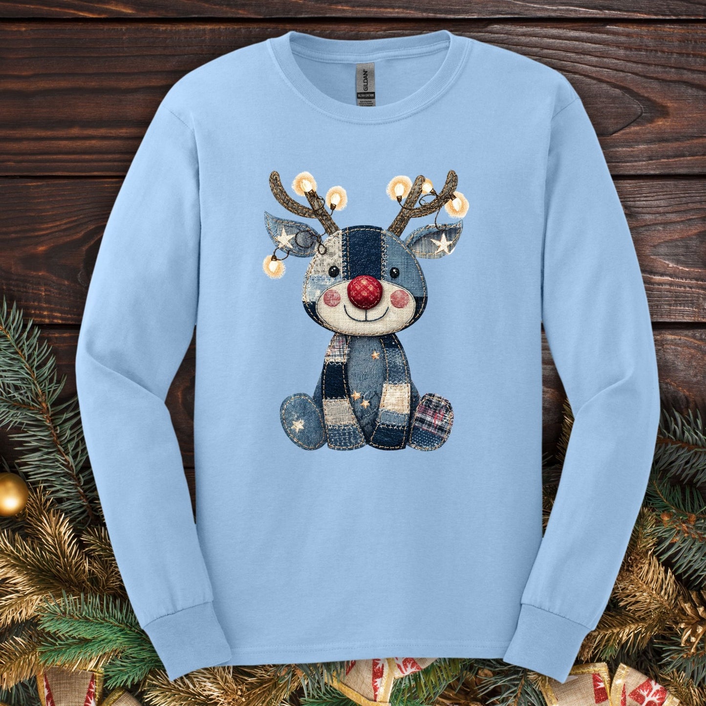 Light blue Gildan long sleeve tee with a faux denim patchwork Rudolph wearing Christmas lights.