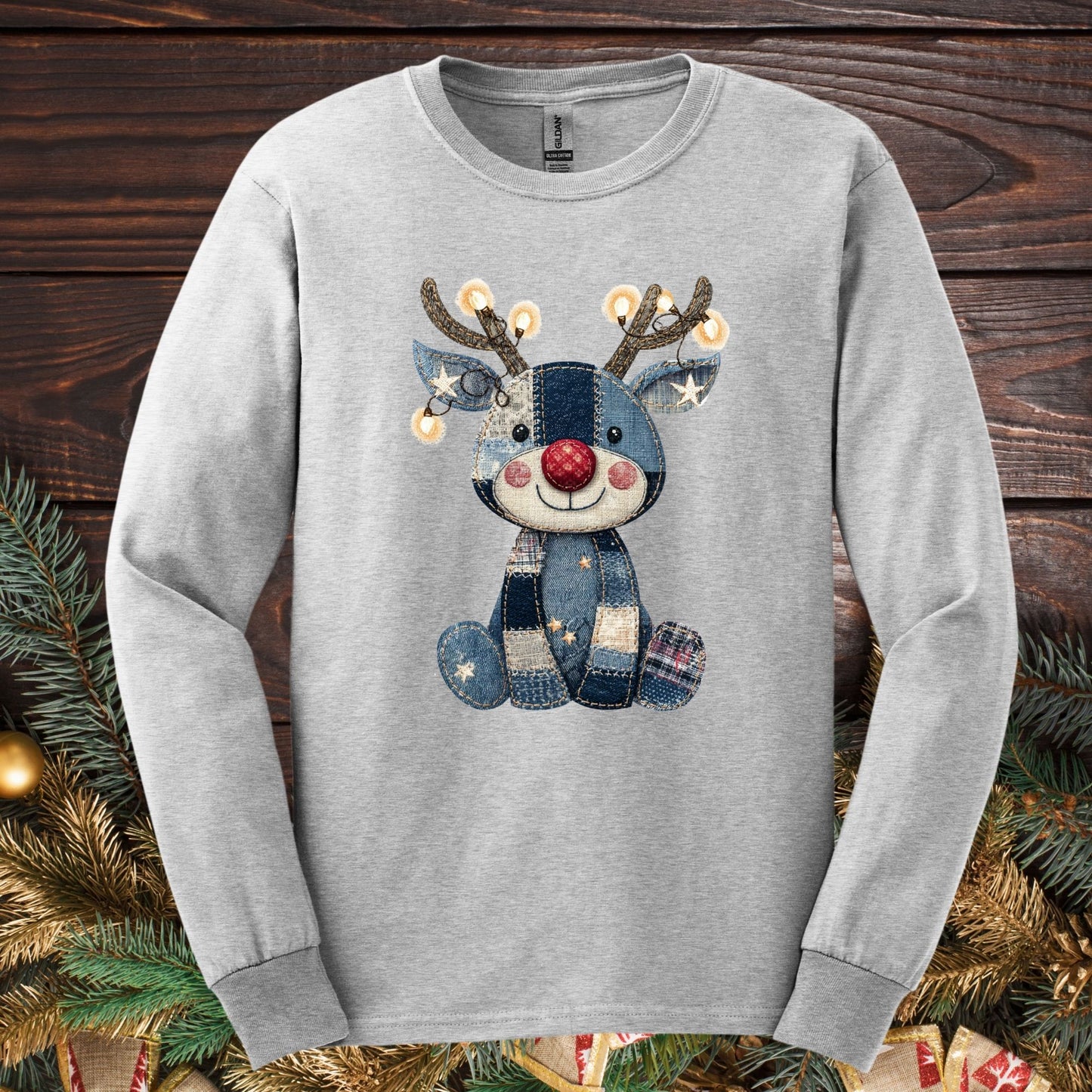 Ash long sleeve tee with a faux denim patchwork Rudolph, antlers sparkling with Christmas lights.