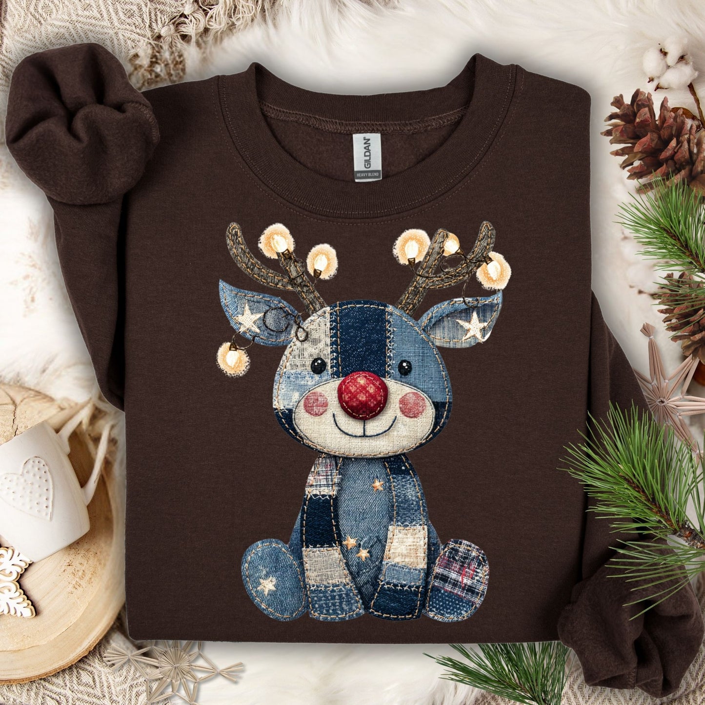 Dark chocolate Gildan sweatshirt with a faux denim patchwork baby Rudolph wearing twinkling lights.