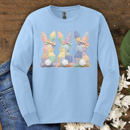 Light blue long sleeve tee with three pastel patchwork bunny tails design.
