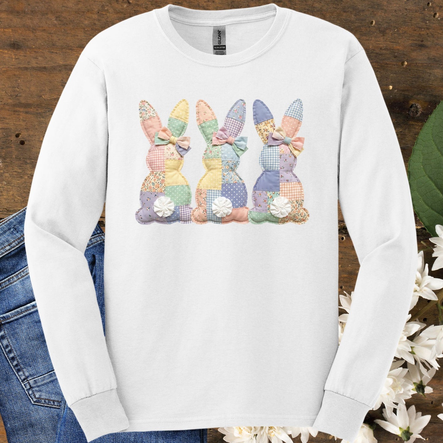 White long sleeve tee with three pastel patchwork bunnies, soft vintage feel.
