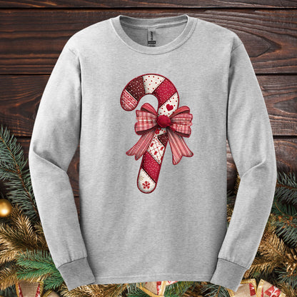 Ash Gildan long sleeve tee with a faux patchwork candy cane and red bow design.