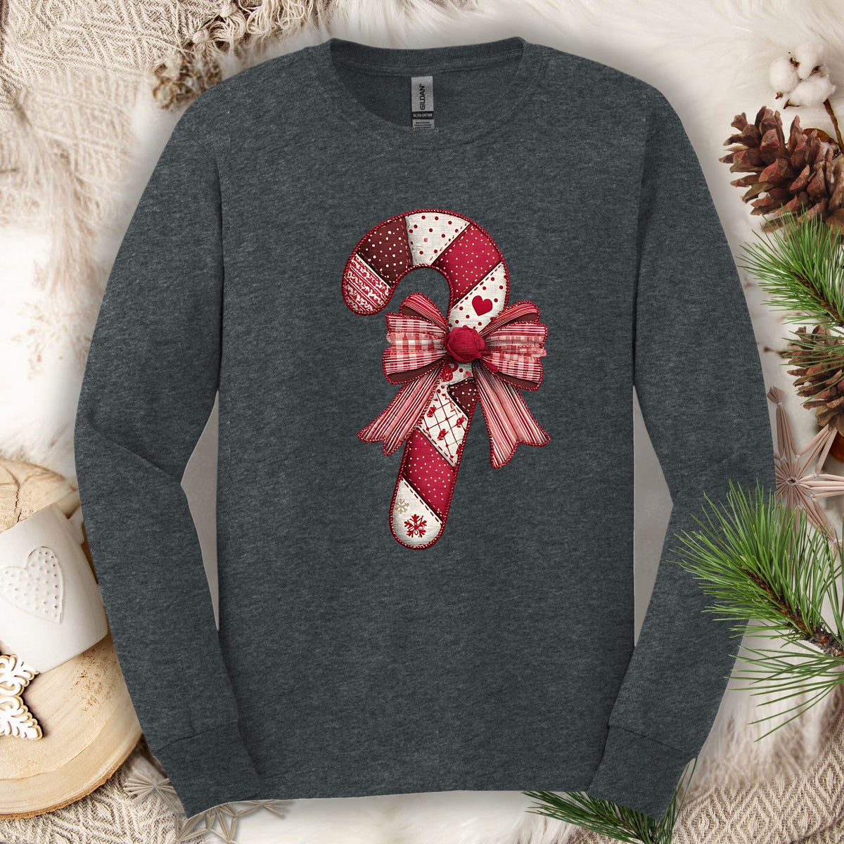 Dark Heather long sleeve tee with a vintage faux patchwork candy cane and red bow design.
