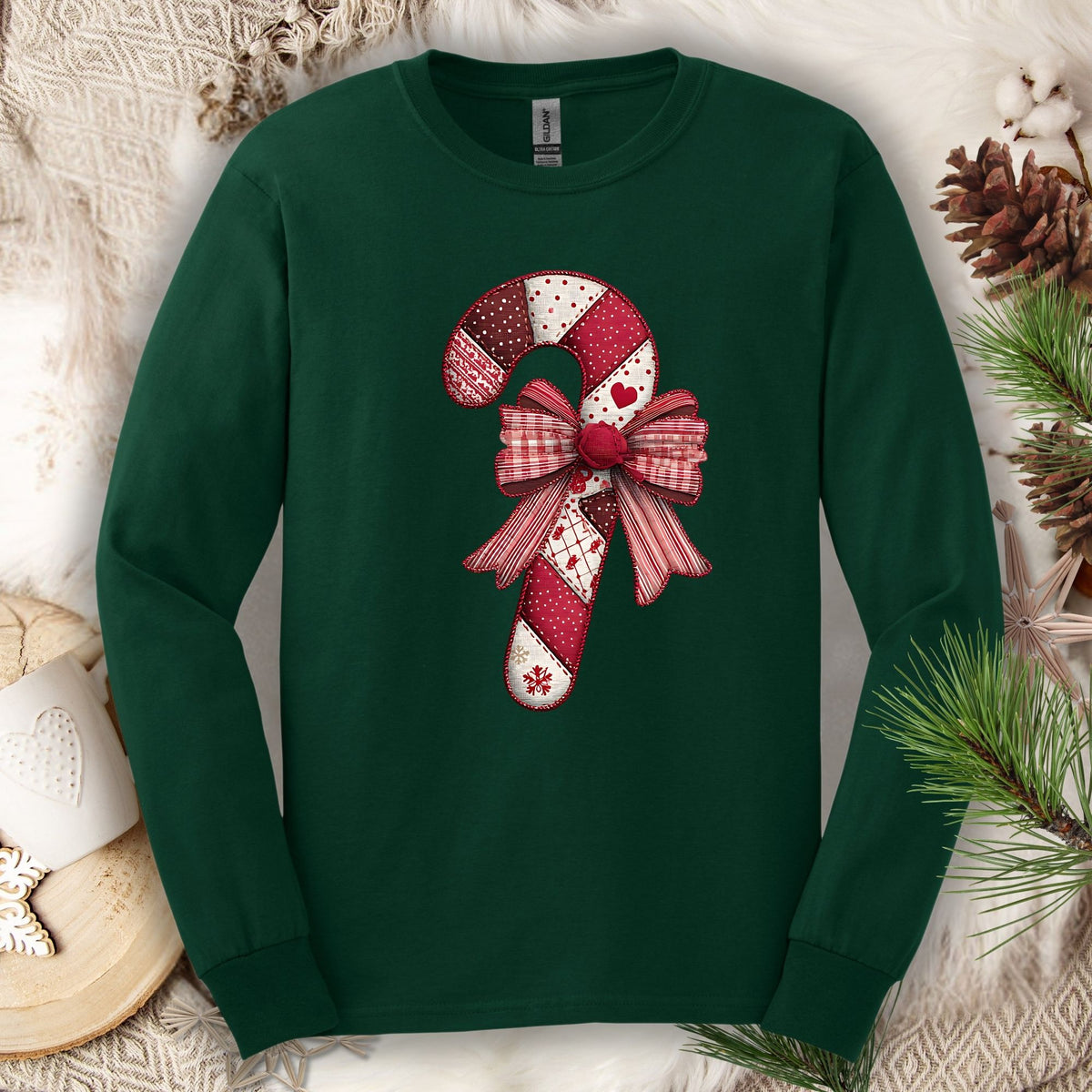 Forest Green long sleeve tee with a vintage faux patchwork candy cane and red bow design.