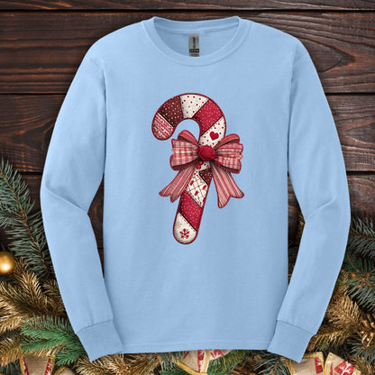 Light blue Gildan long sleeve tee with a vintage faux patchwork candy cane and red bow design.