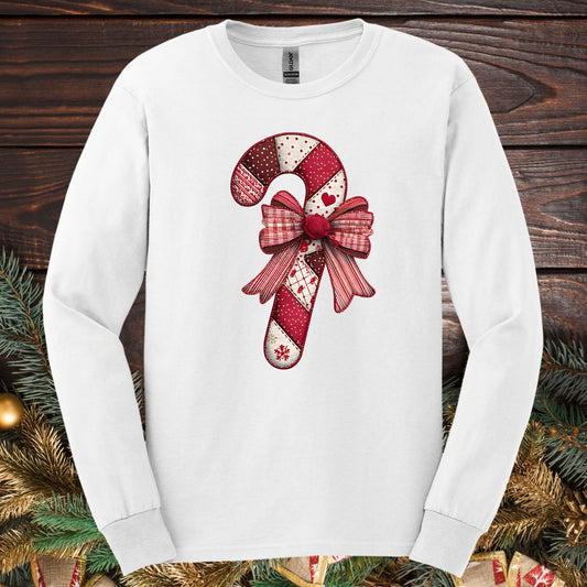 White Gildan long sleeve tee with a vintage faux patchwork candy cane and red bow design.