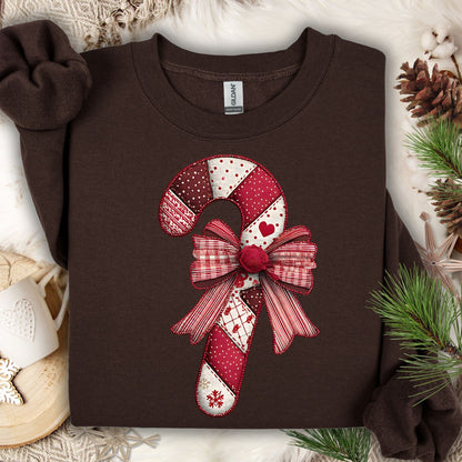 Dark chocolate Gildan sweatshirt with a vintage faux patchwork candy cane and red bow design.