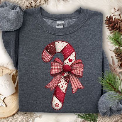 Dark Heather Gildan sweatshirt with a vintage faux patchwork candy cane and red bow design.