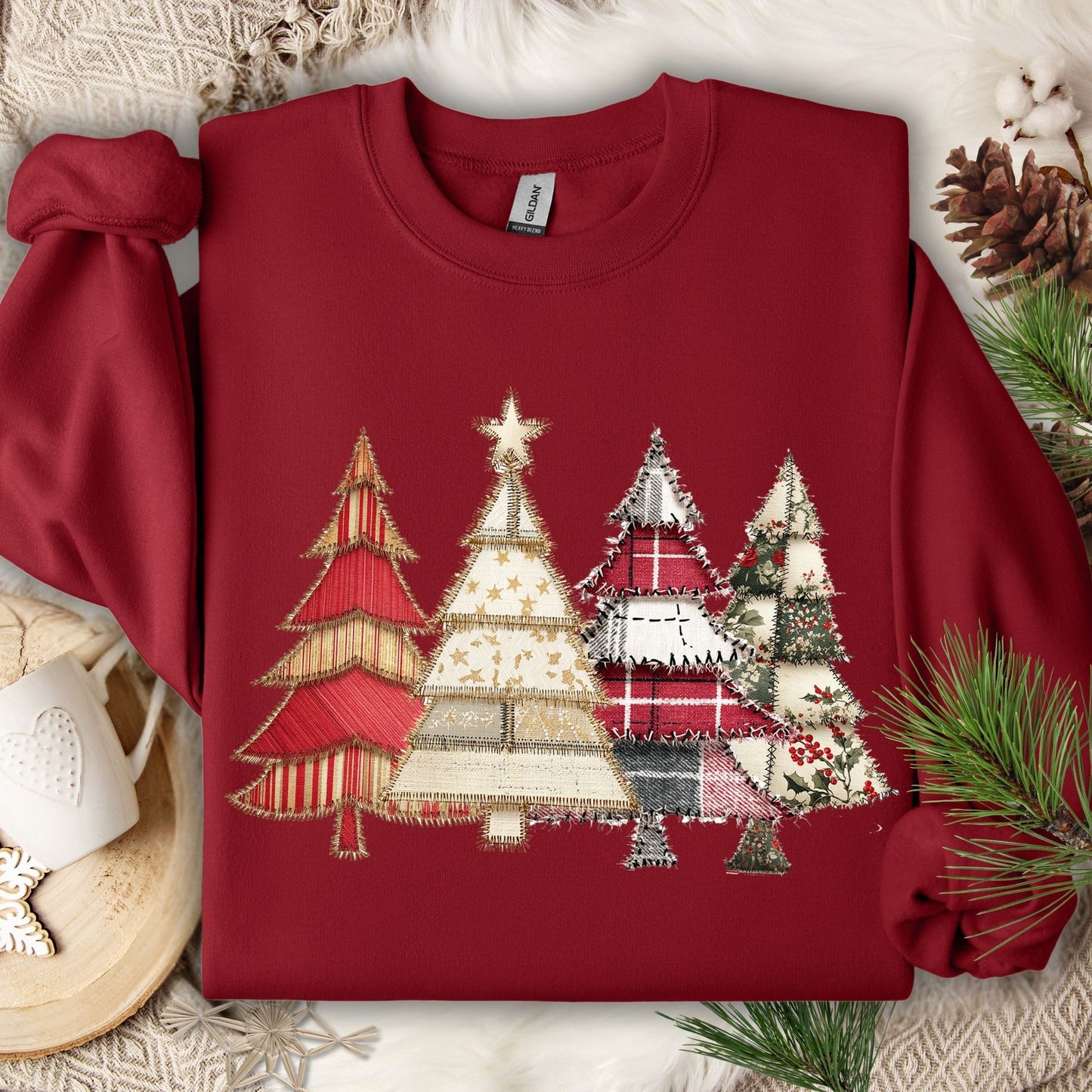 Cardinal Red Gildan sweatshirt with a faux patchwork print of four rustic Christmas trees.