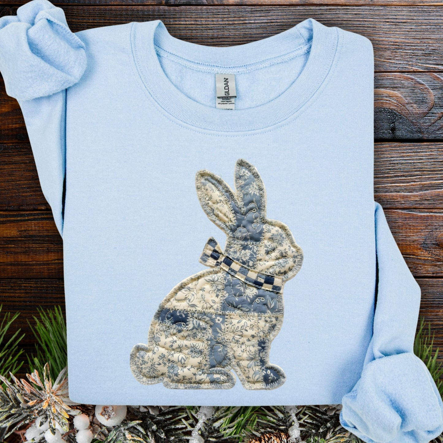 Light blue faux patchwork bunny sweatshirt with blue and white country pattern.