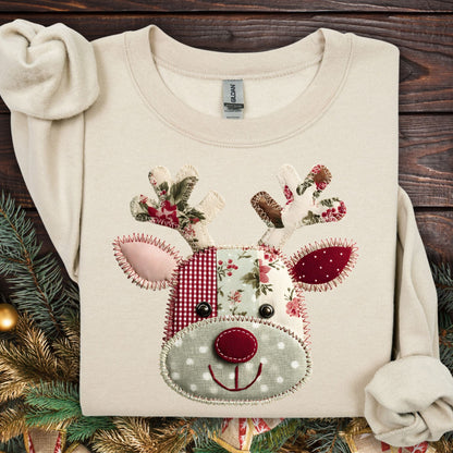 Sand Gildan sweatshirt with a patchwork Rudolph face featuring gingham, polka dot, and floral fabrics in sage green and rustic red.