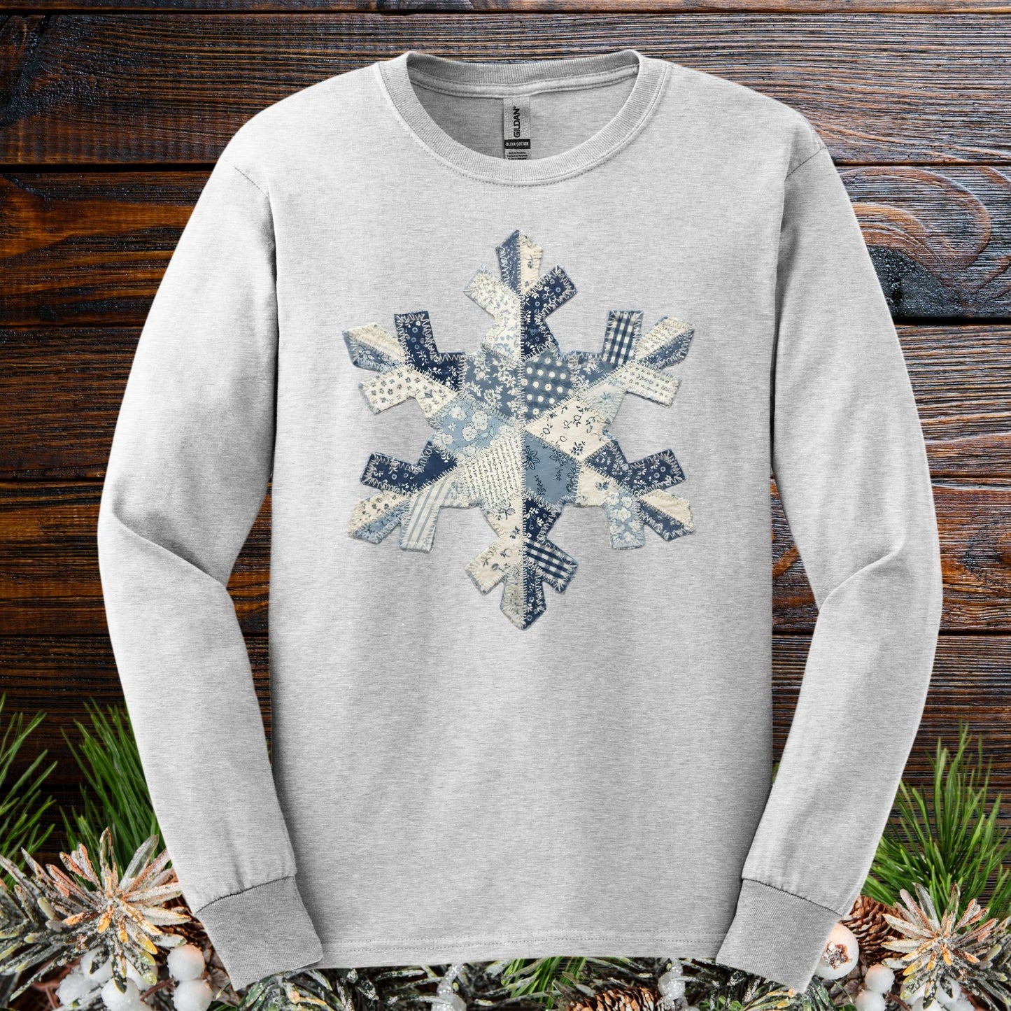 Ash gray long sleeve tee with a blue and white faux patchwork snowflake design.