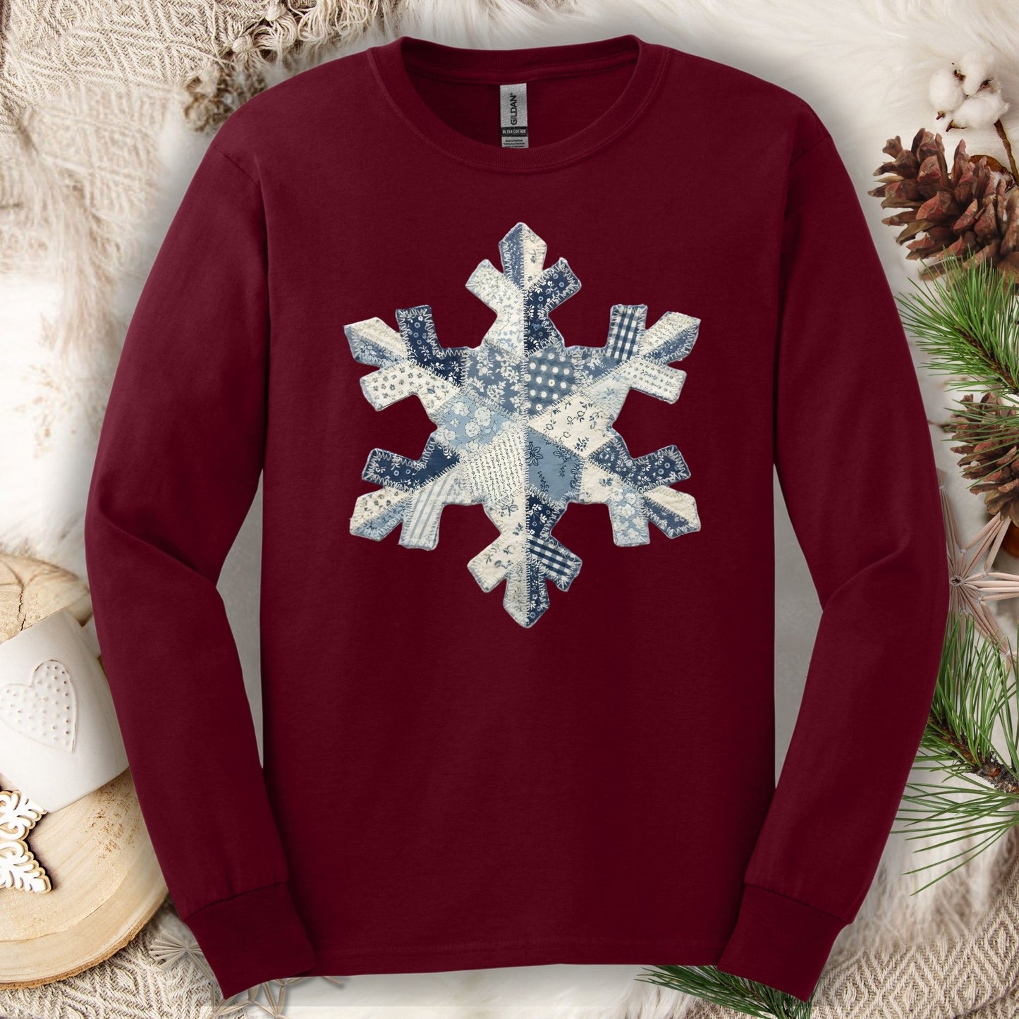 Maroon long sleeve tee with a faux patchwork blue and white country snowflake design.