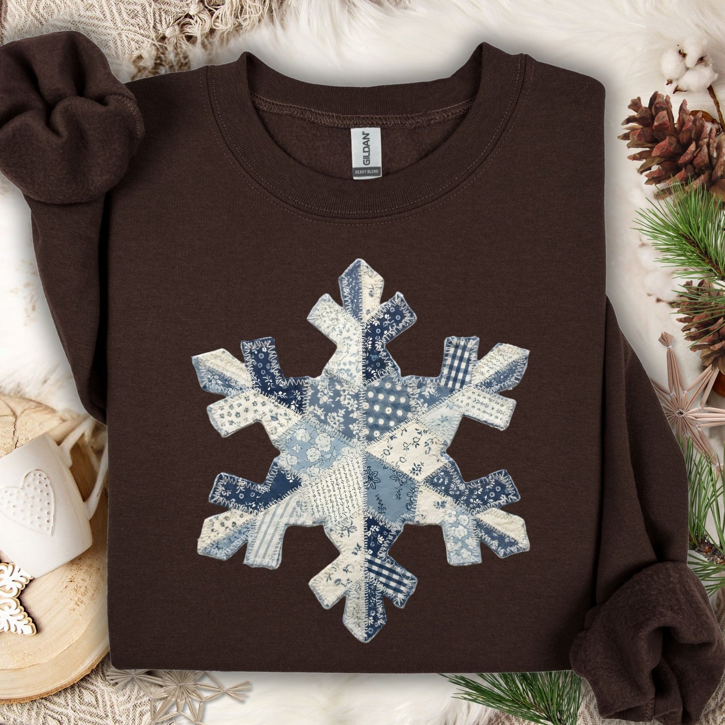 Dark chocolate sweatshirt with a large blue and white faux patchwork snowflake design.