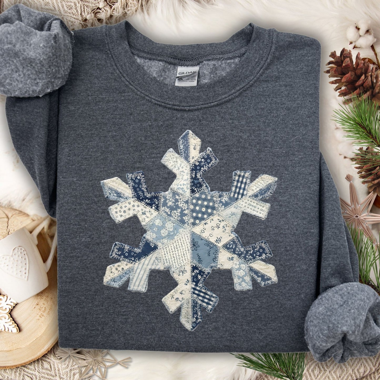 Dark Heather S sweatshirt with a blue and white faux patchwork snowflake design.
