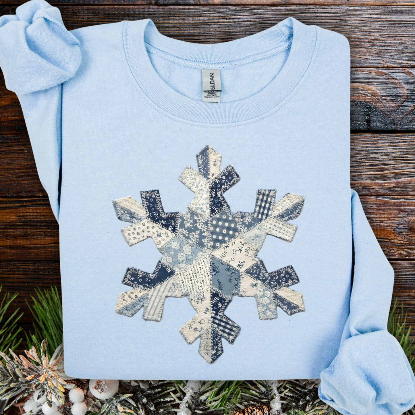 Light blue S sweatshirt with a faux patchwork blue and white snowflake design.