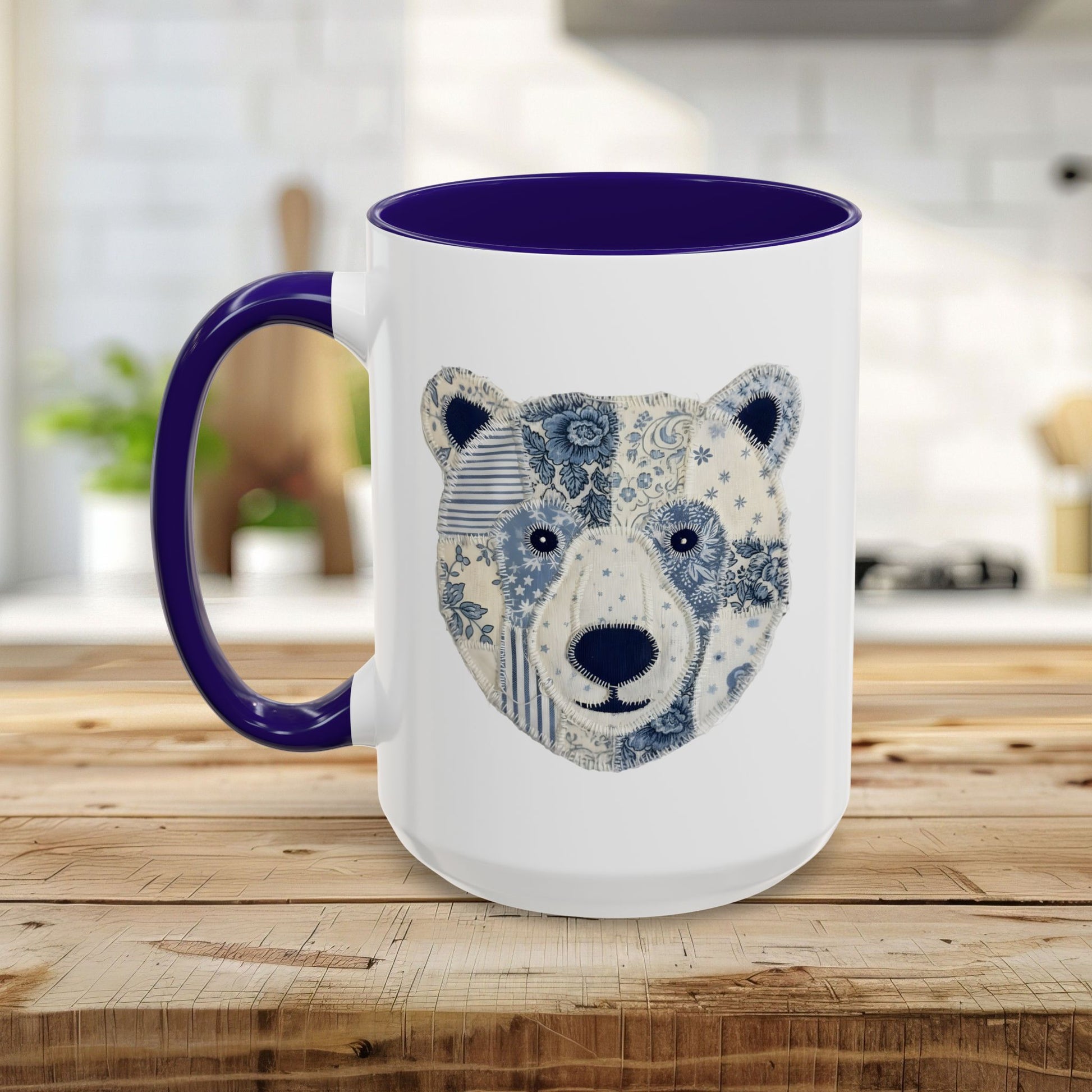 White ceramic mug with blue faux patchwork winter bear design, blue rim and handle.