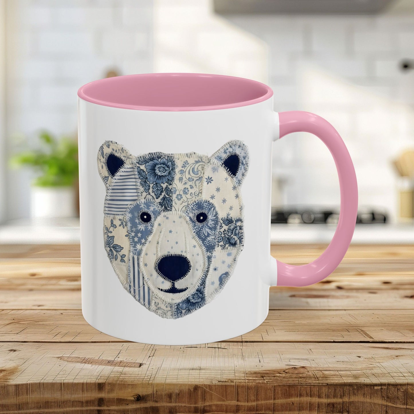 11oz white ceramic mug with pink rim/handle and blue/white faux patchwork winter bear design.