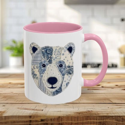 11oz white ceramic mug with pink rim/handle and blue/white faux patchwork winter bear design.