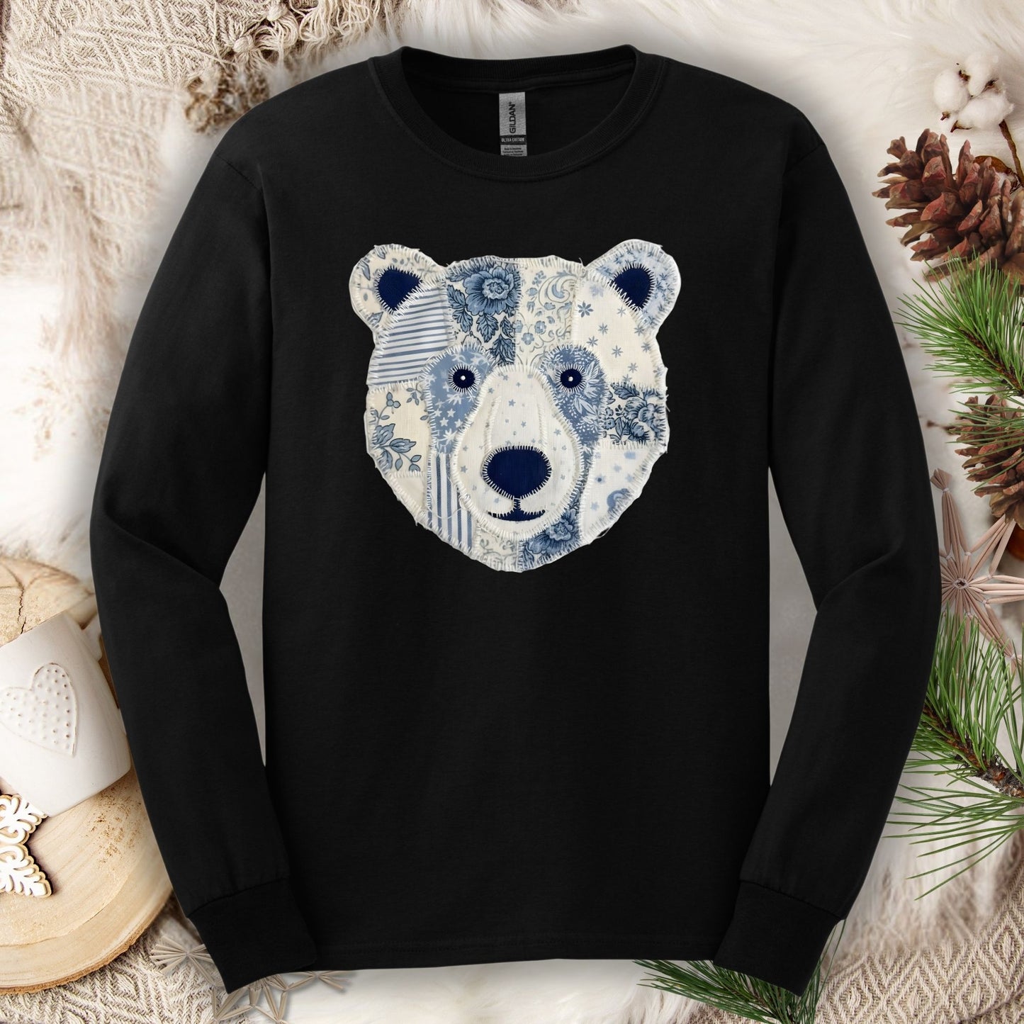 Black long-sleeve tee with a faux patchwork blue and white winter bear face design.