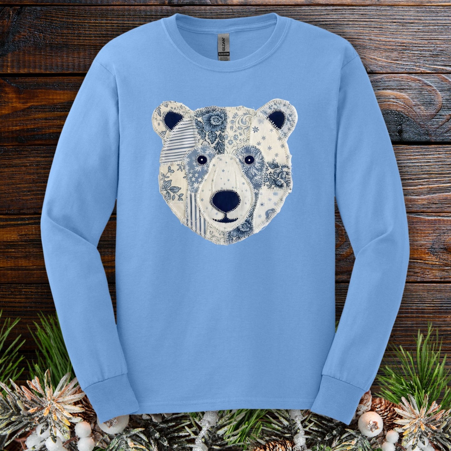 Carolina Blue long sleeve tee with a faux patchwork winter bear face design.