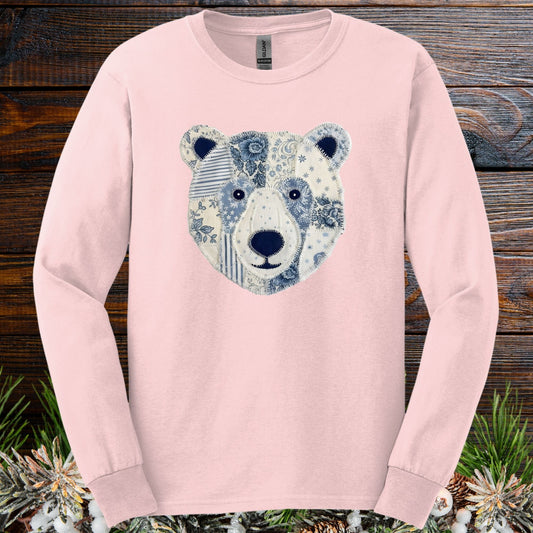 Light pink long sleeve tee with a faux patchwork blue and white winter bear face design.