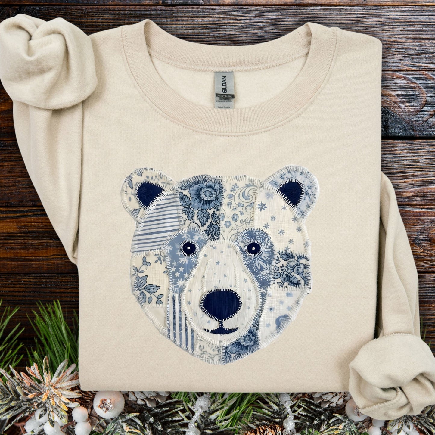 Sand S sweatshirt with blue and white faux patchwork country winter bear design.