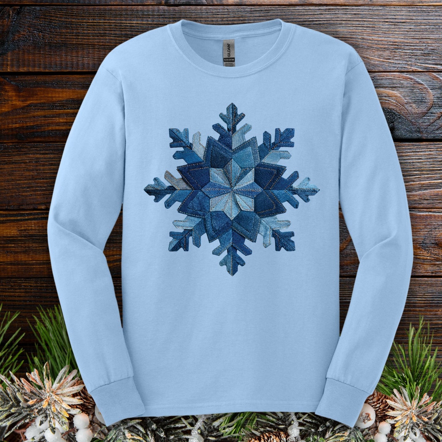 Light blue long sleeve tee with a faux patchwork denim snowflake design.