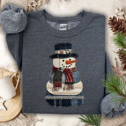 Dark Heather Gildan sweatshirt with a faux patchwork denim snowman design.