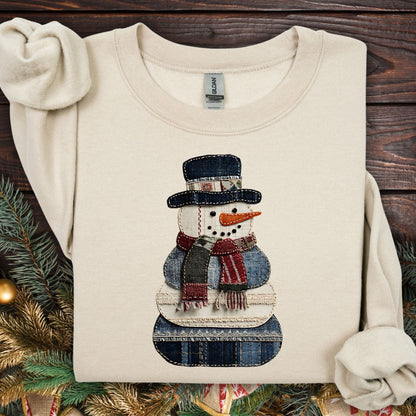 Sand Gildan sweatshirt with a faux patchwork denim snowman design.