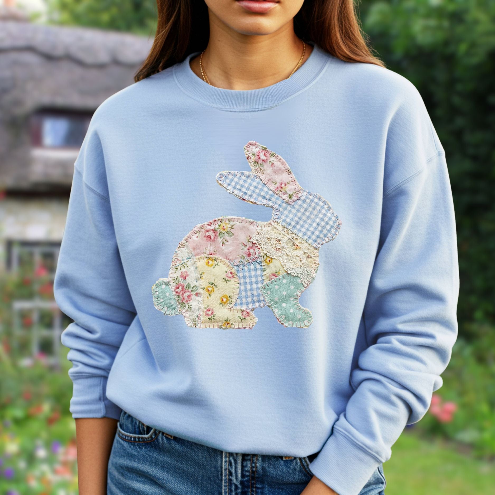 Light blue crewneck sweatshirt with a patchwork floral and gingham bunny applique.