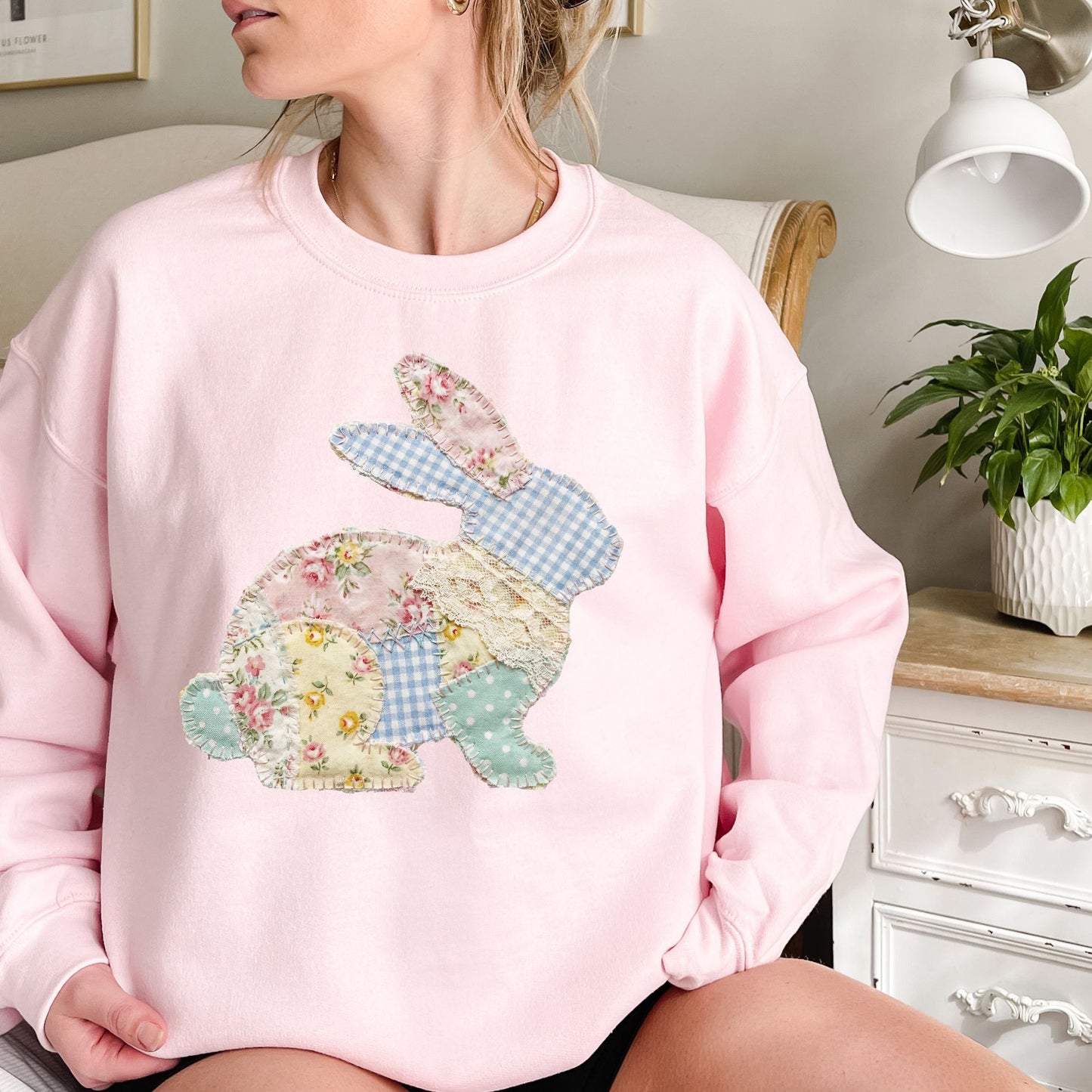 Pink crewneck sweatshirt with a patchwork floral and gingham bunny design.