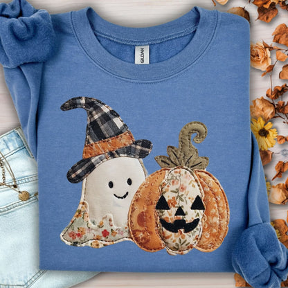 Indigo blue Gildan sweatshirt with a faux patchwork ghost in a plaid witch hat and floral jack-o-lantern.