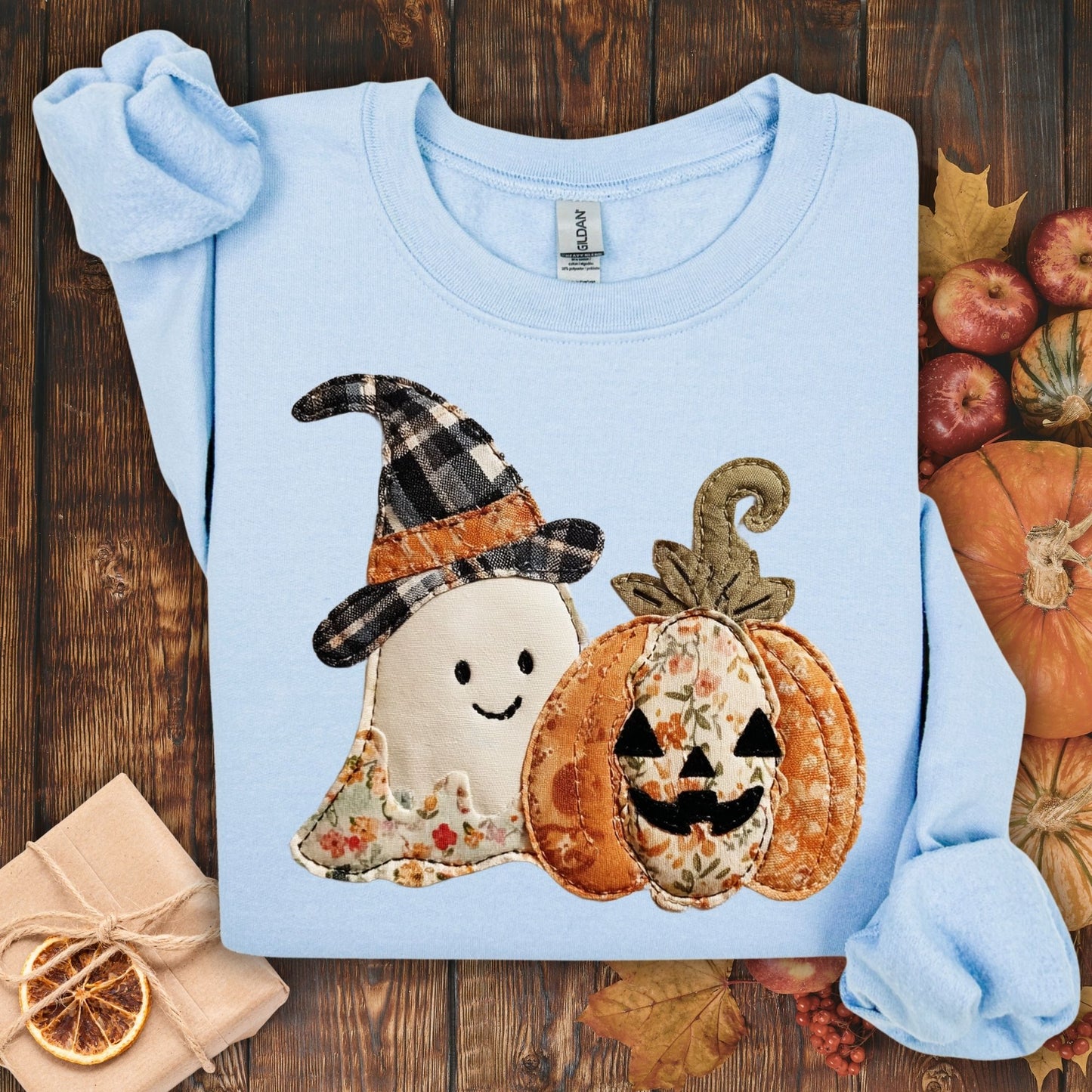 Light blue Gildan sweatshirt with faux patchwork ghost in witch hat and jack-o-lantern.