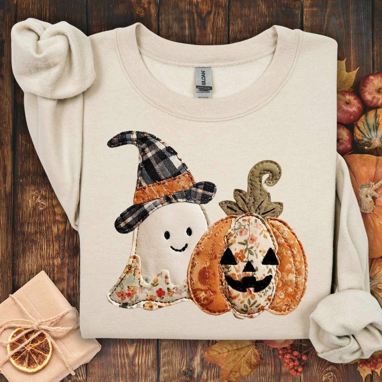 Sand crewneck sweatshirt with faux patchwork ghost in witch hat and jack-o-lantern.