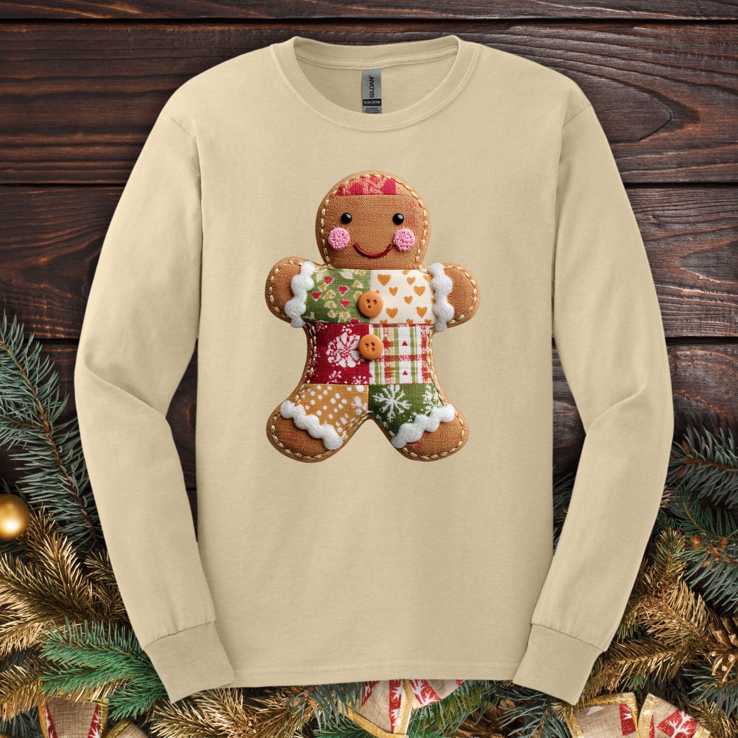 Sand Gildan long sleeve tee with a faux patchwork gingerbread man design.