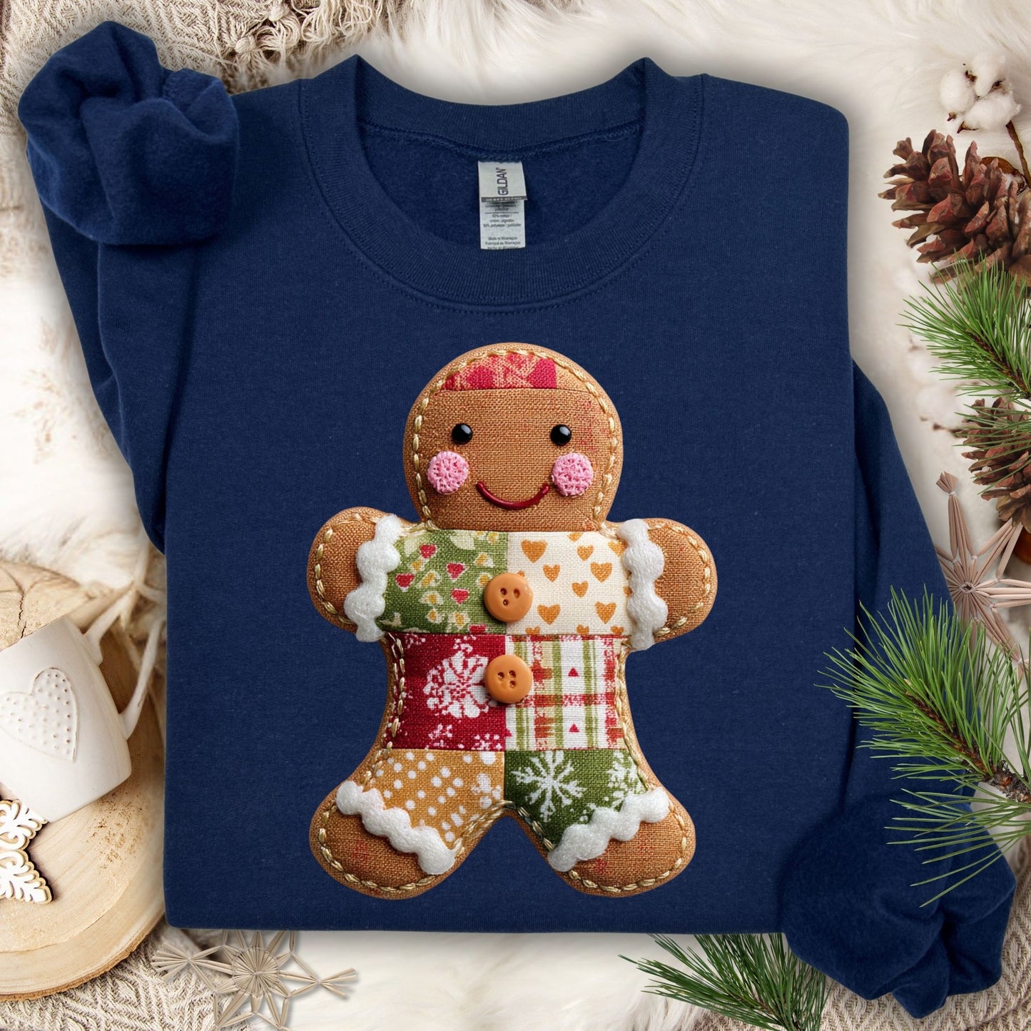 Navy Gildan fleece sweatshirt with a faux patchwork gingerbread man design, surrounded by holiday decor.