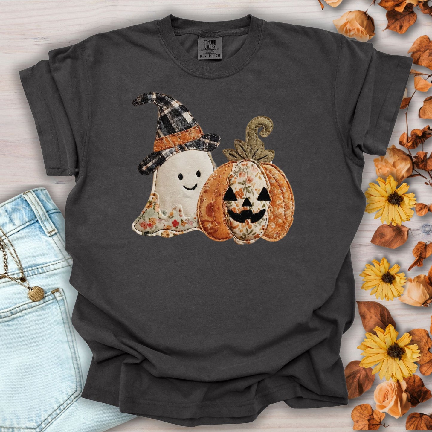 Pepper Comfort Colors t-shirt with a faux patchwork ghost in a plaid hat and a floral jack o'lantern.