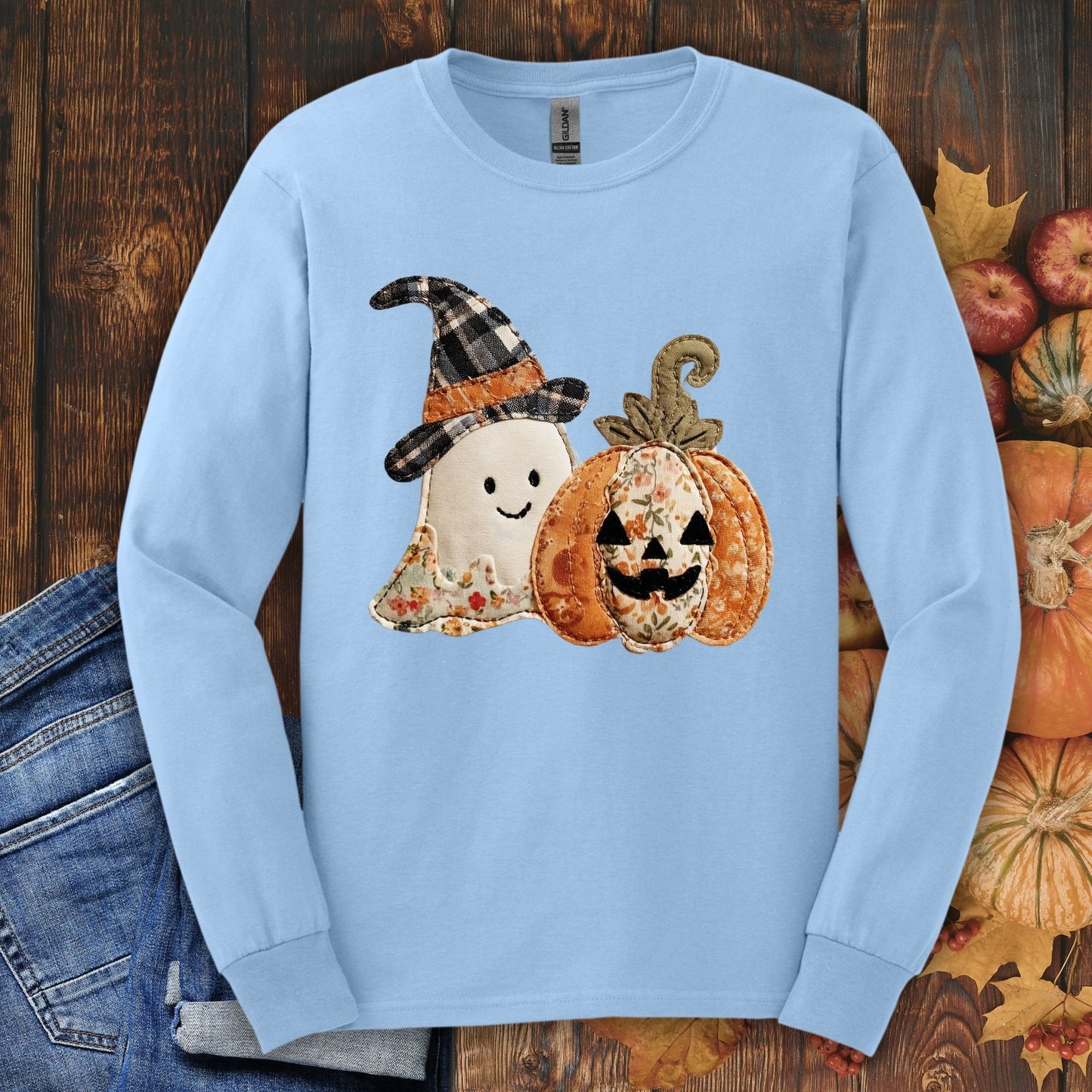 Light blue long sleeve tee with a faux patchwork ghost in a witch hat and a floral pumpkin.