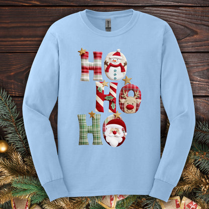 Light blue long sleeve 100% cotton tee with faux patchwork "Ho Ho Ho" design featuring Santa, Rudolph, and a snowman.