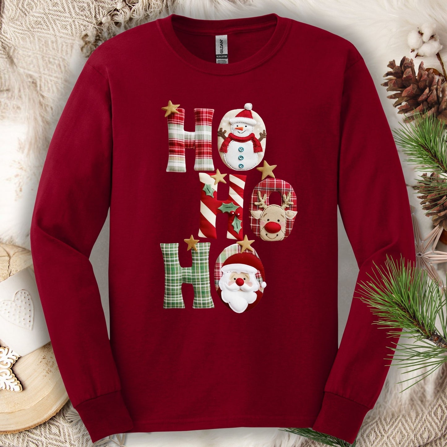 Cardinal Red long sleeve tee with faux patchwork "Ho Ho Ho" design featuring Santa, Rudolph, and a snowman.