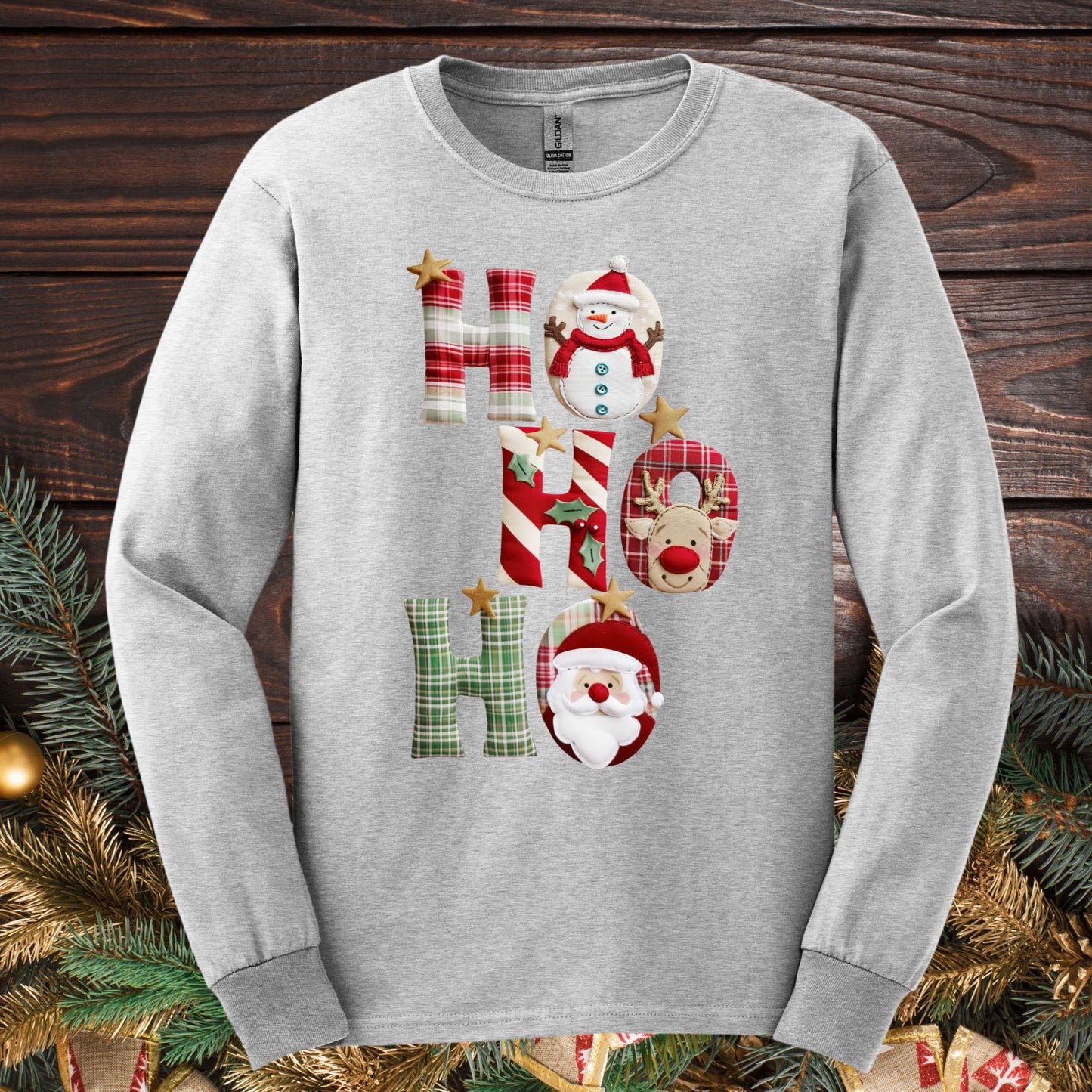 Ash long sleeve tee with faux patchwork "Ho Ho Ho" design featuring Santa, Rudolph, and a snowman.