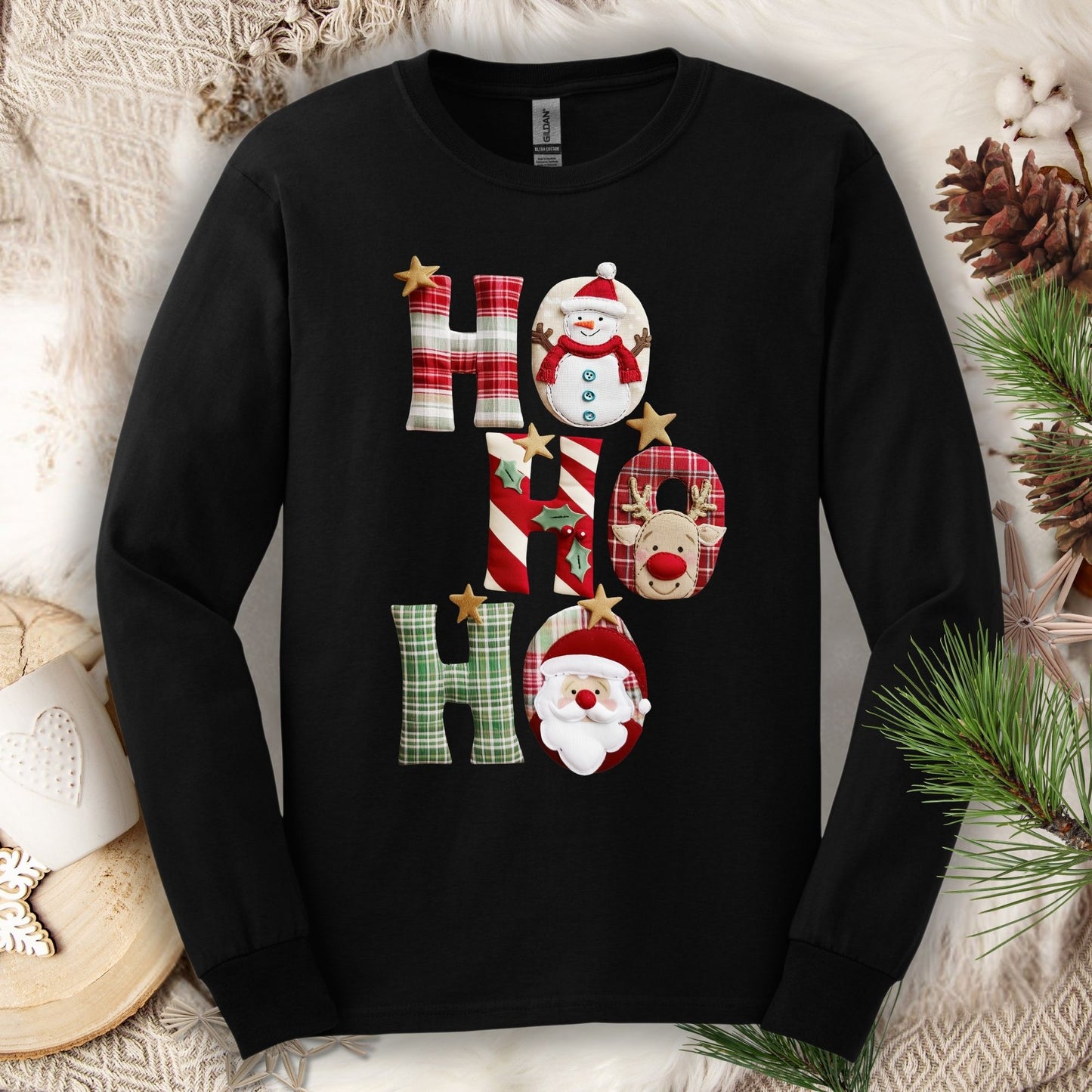 Black long sleeve tee with faux patchwork "Ho Ho Ho" design featuring Santa, Rudolph, and a snowman.
