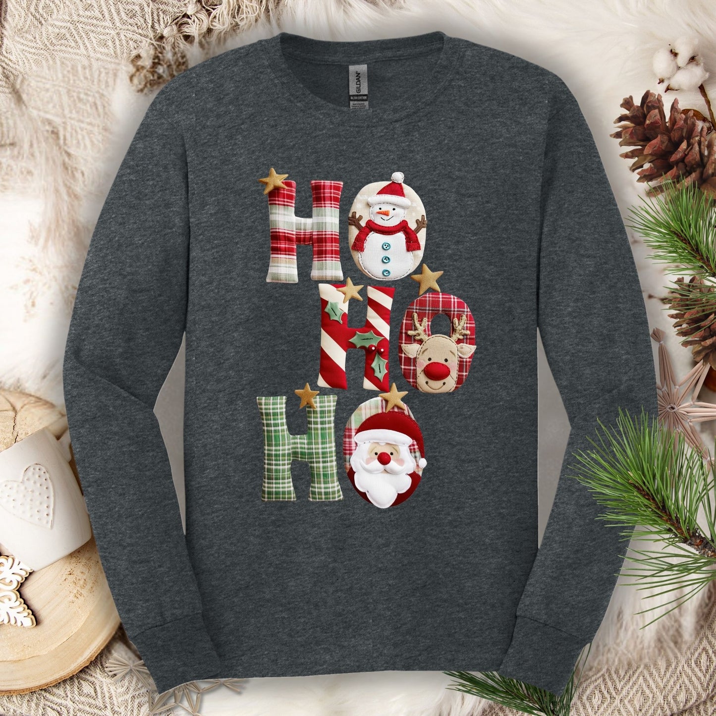 Dark heather long sleeve tee with faux patchwork "Ho Ho Ho" design featuring Santa, Rudolph, and a snowman.