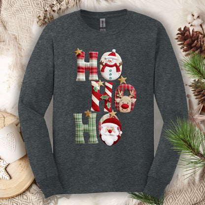 Dark heather long sleeve tee with faux patchwork "Ho Ho Ho" design featuring Santa, Rudolph, and a snowman.