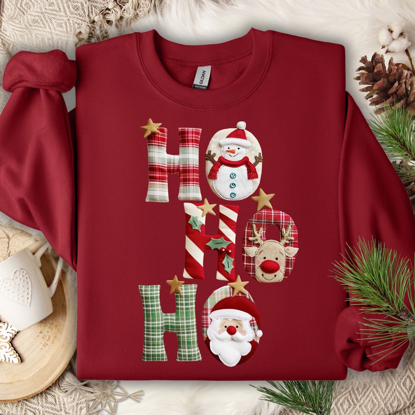 Cardinal Red Gildan sweatshirt with faux patchwork "Ho Ho Ho" design featuring Santa, Rudolph, and a snowman.