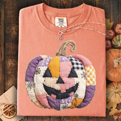 Faux patchwork jack-o'-lantern t-shirt in soft pink, purple, and orange cottage core tones.