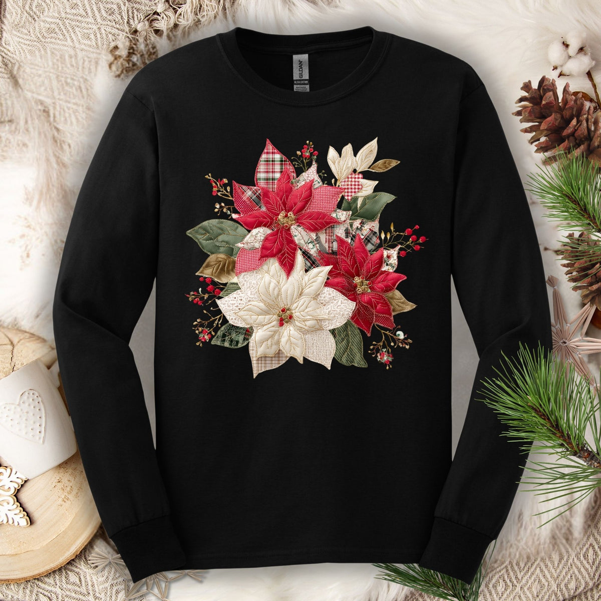Black long sleeve tee with a faux patchwork poinsettia design featuring red, white, gingham, and plaid fabrics.